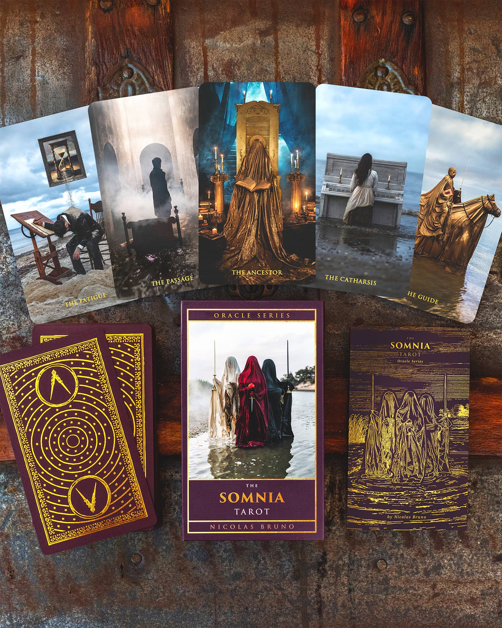 Collection of tarot cards with artistic designs on a wooden surface