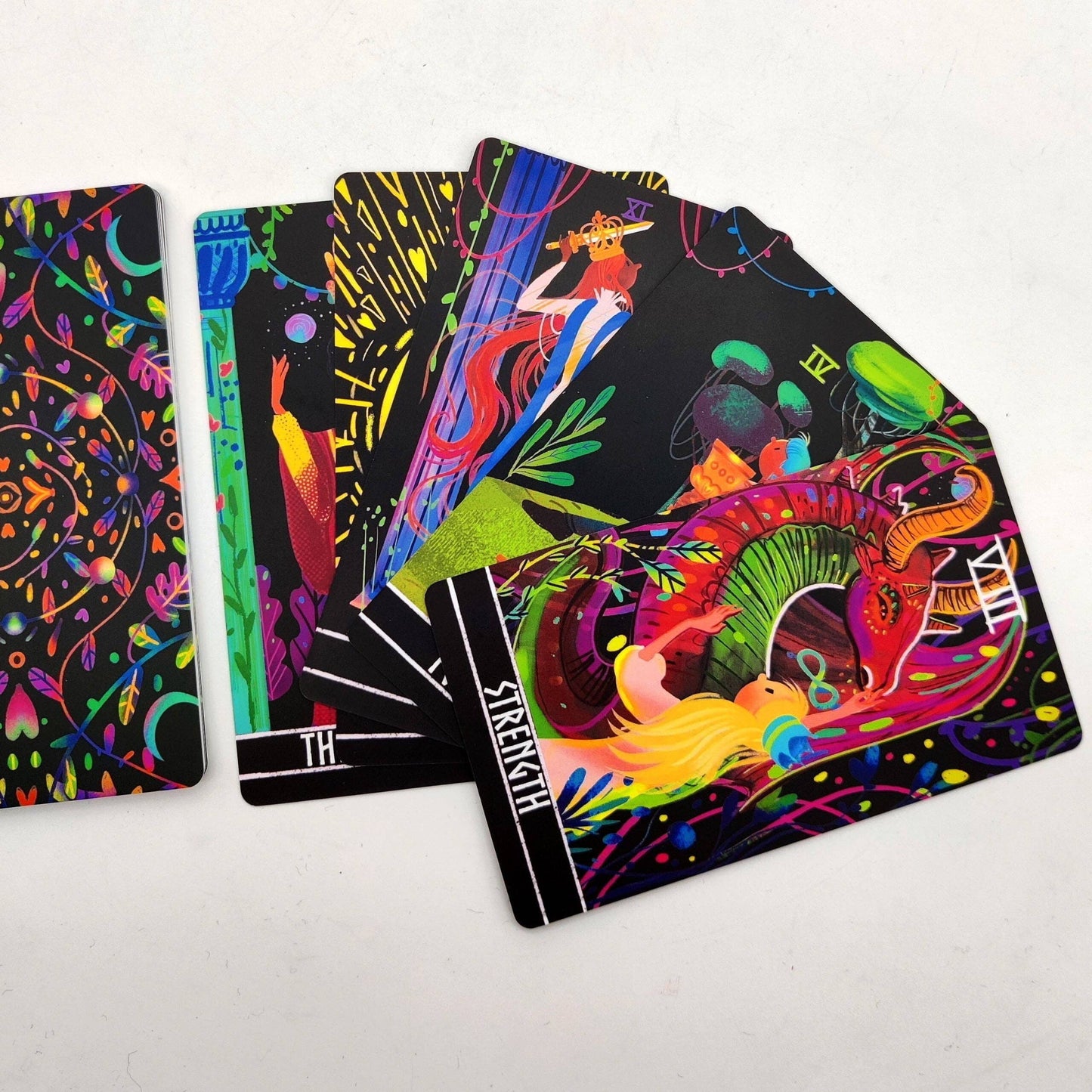 Colorful tarot cards with intricate designs on a white background