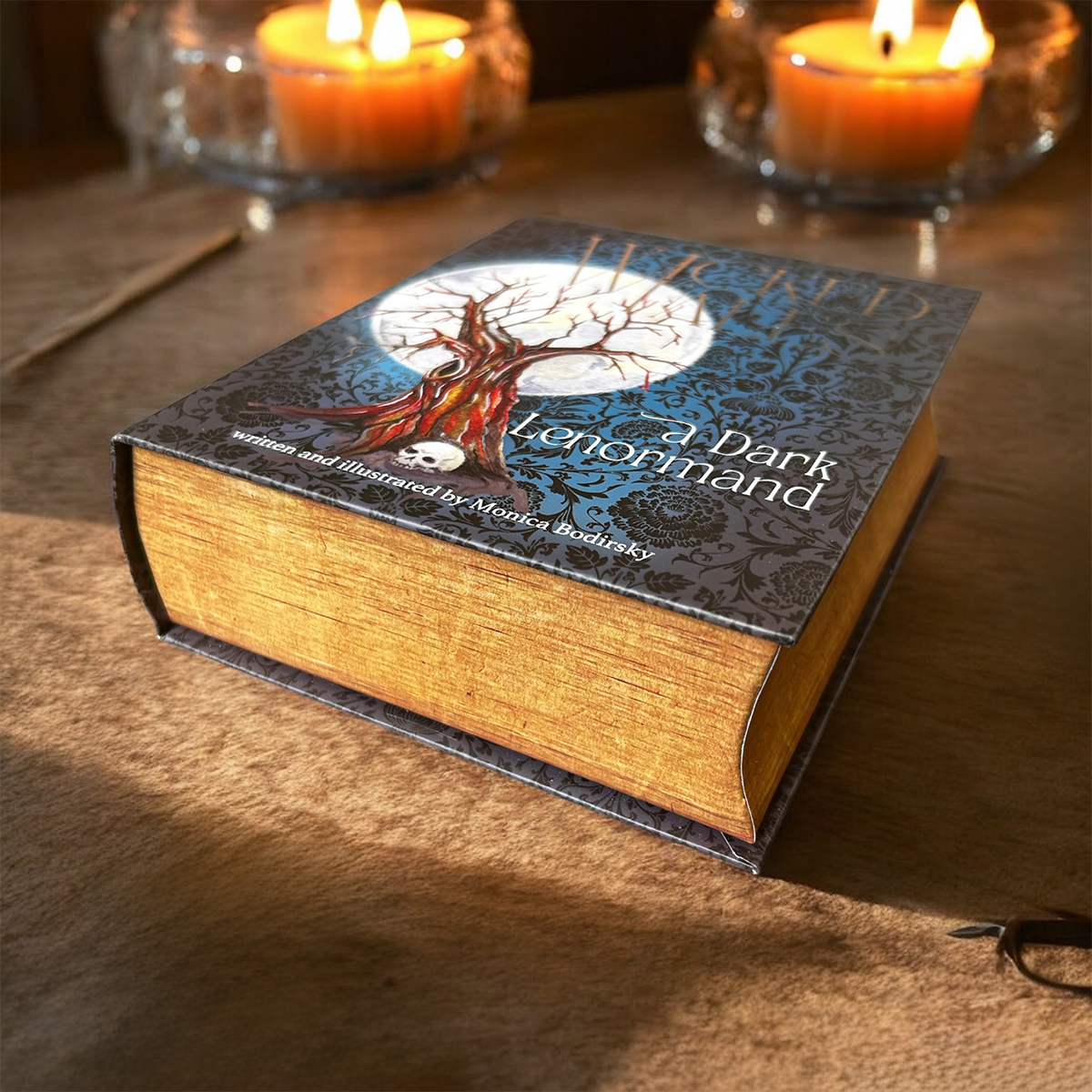 Book titled 'A Dark Lenormand' with candlelight in the background