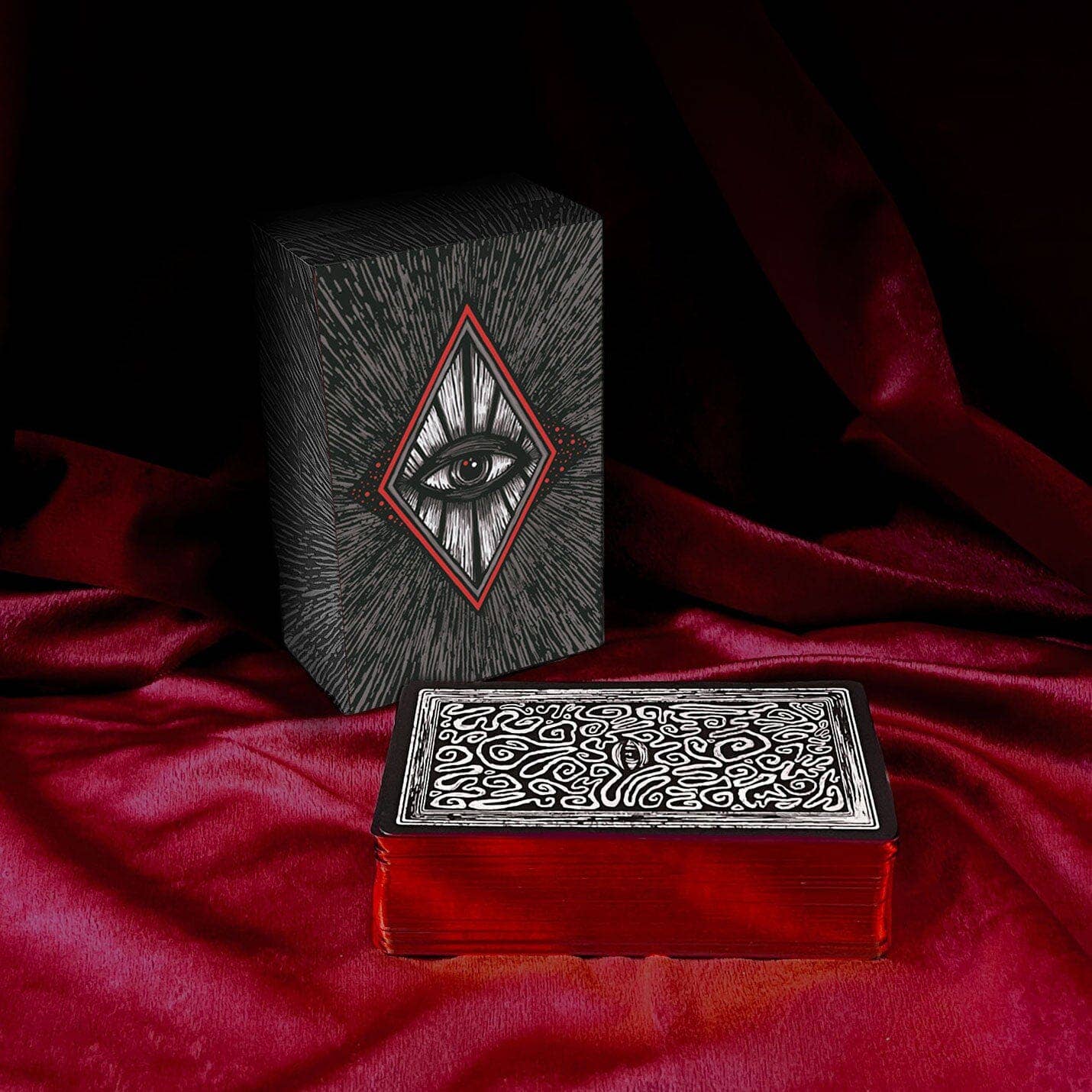 Decorative box with eye design on a red fabric background