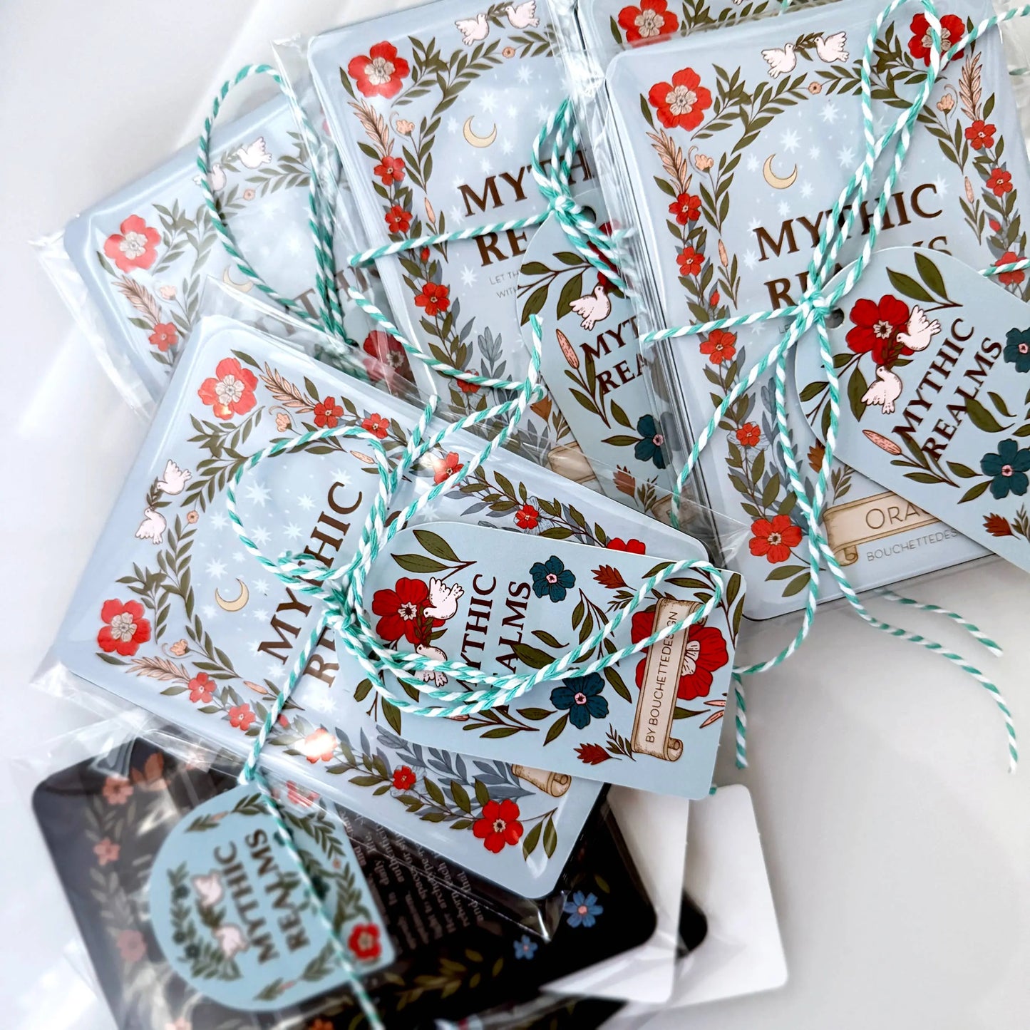 Packaged sheets with floral designs and 'Mythic Rems' branding on a white surface.