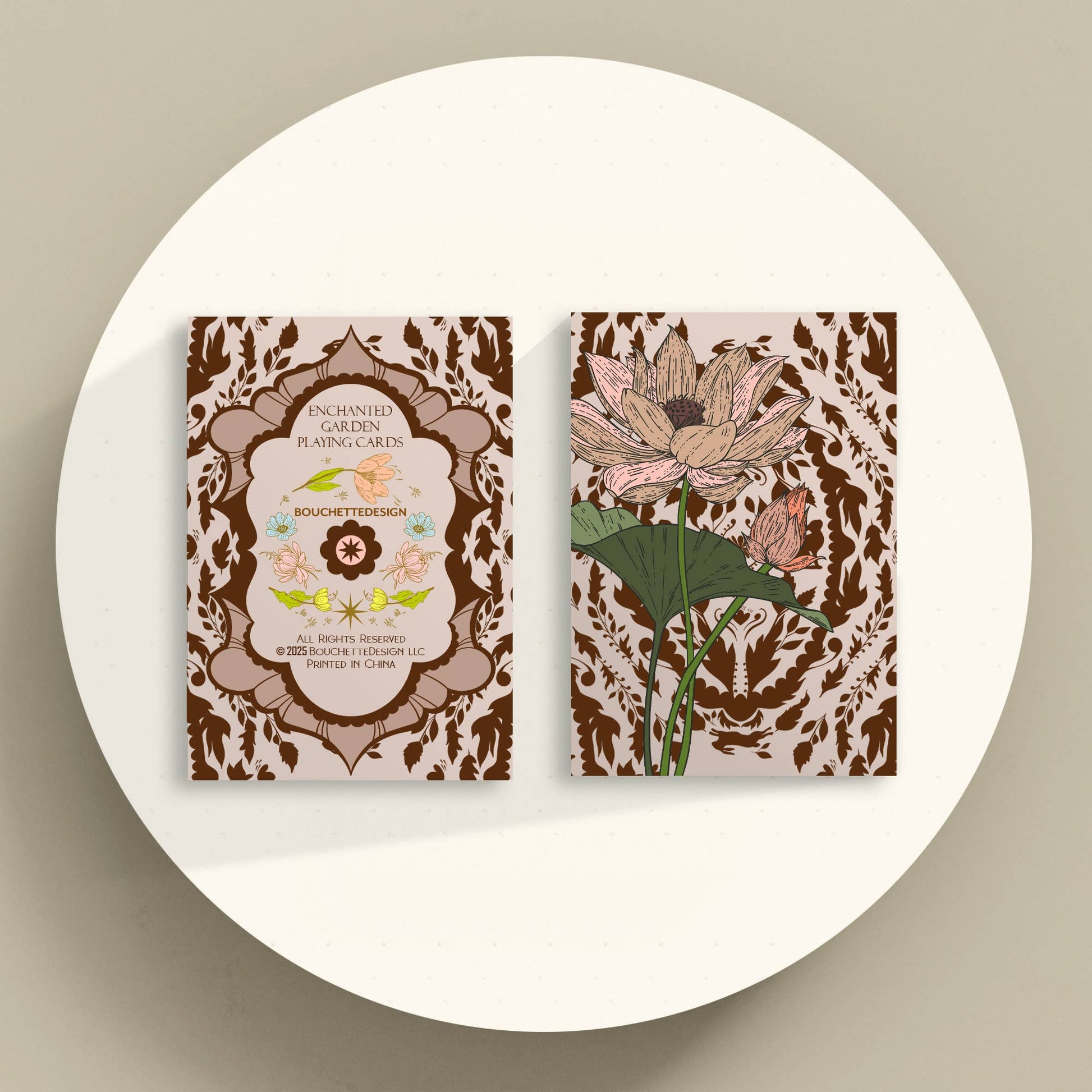 Two card decks with floral designs on a beige background