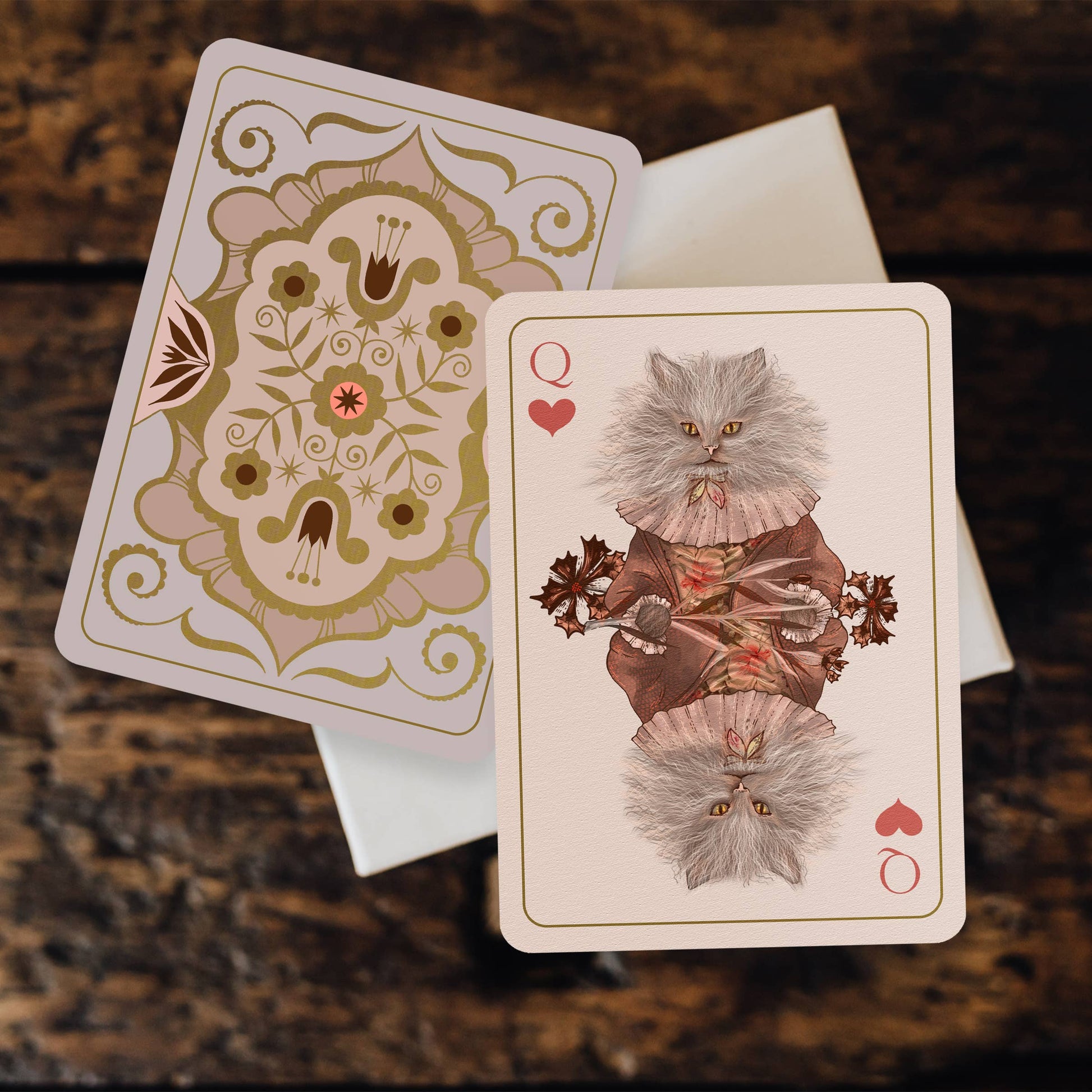 Playing cards with decorative designs on a textured surface