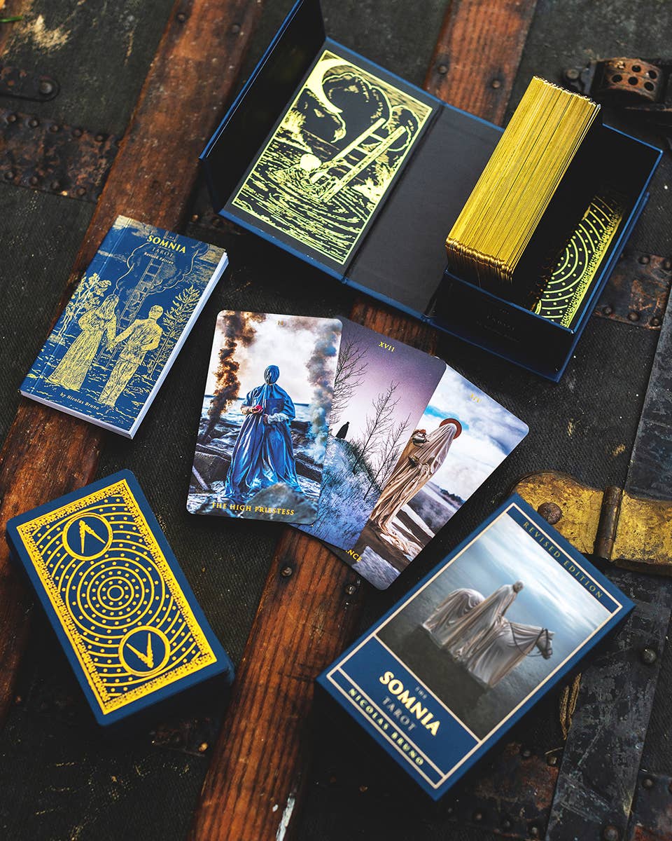 Collection of 'Somnia' tarot cards on a rustic wooden surface
