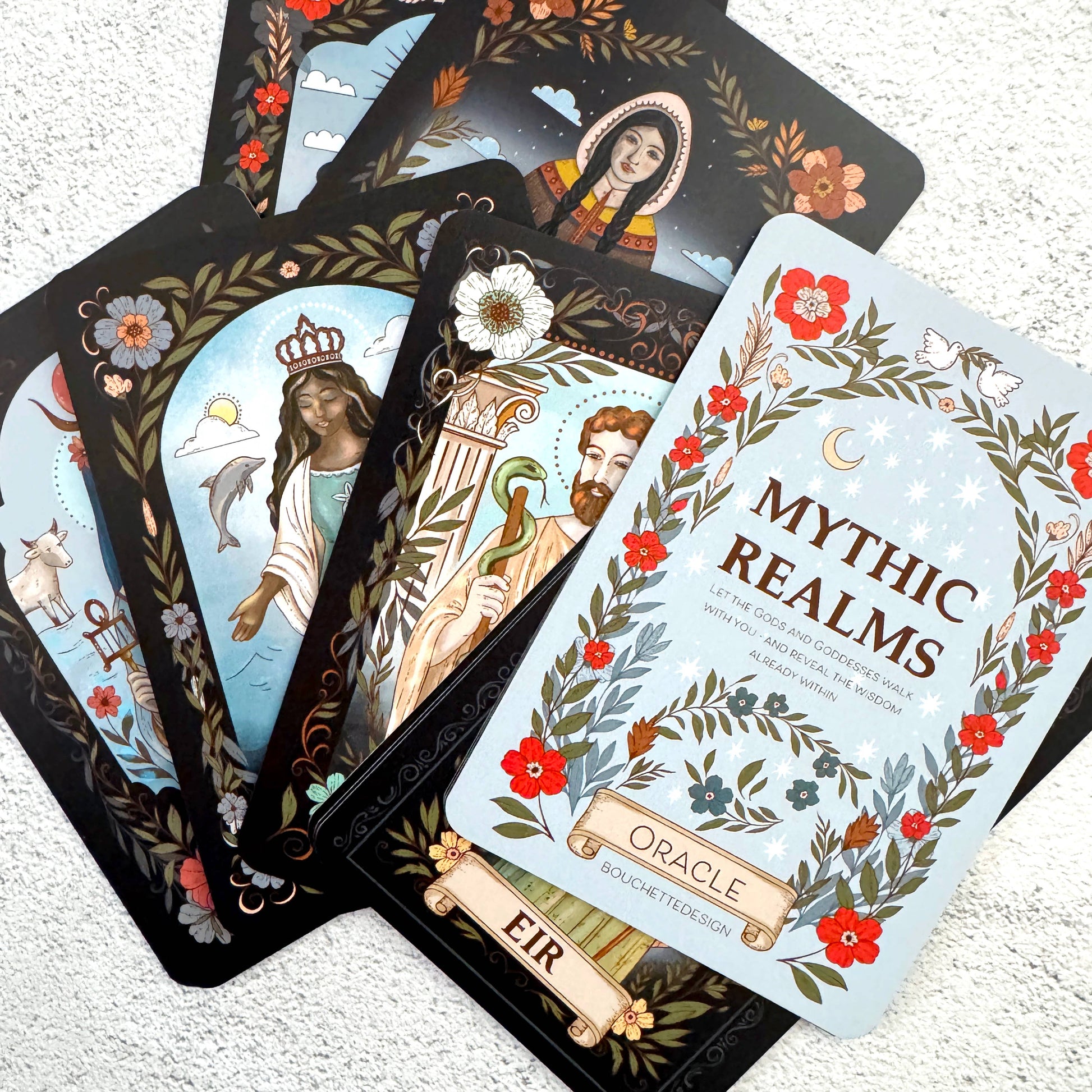 Set of Mythic Realms Oracle cards on a textured surface