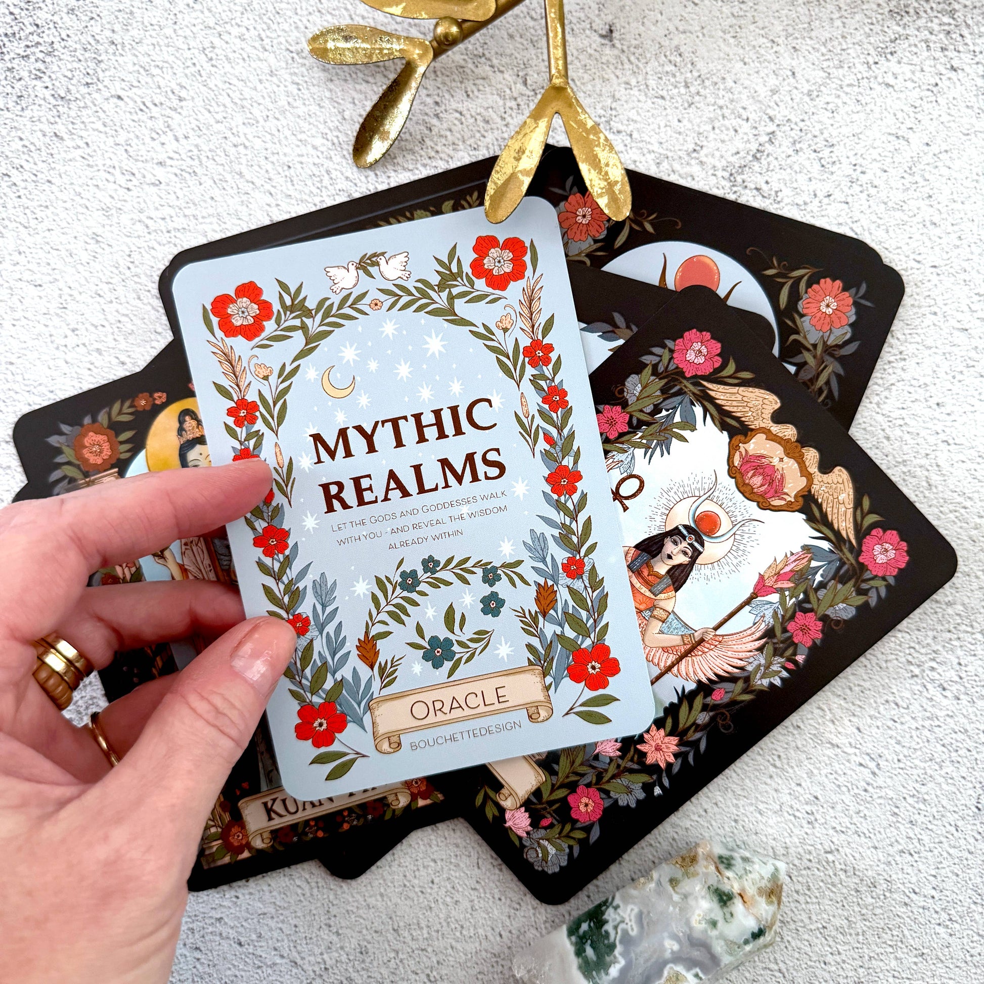 Goddess oracle cards on granite background with pointed crystal