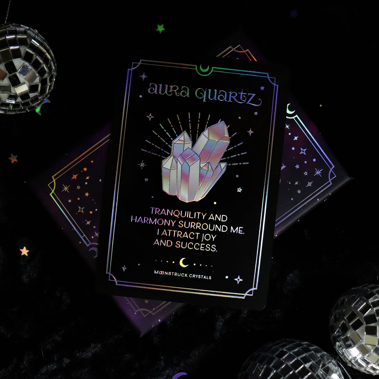 Card with crystal design and text on a dark background with disco balls