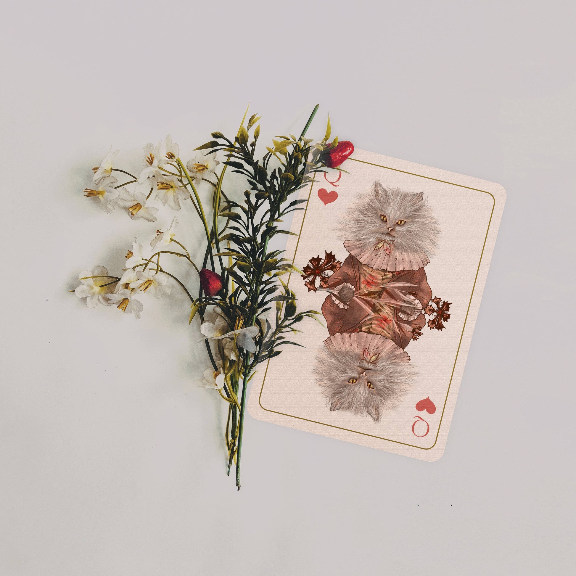 Playing card with floral design on a light gray background