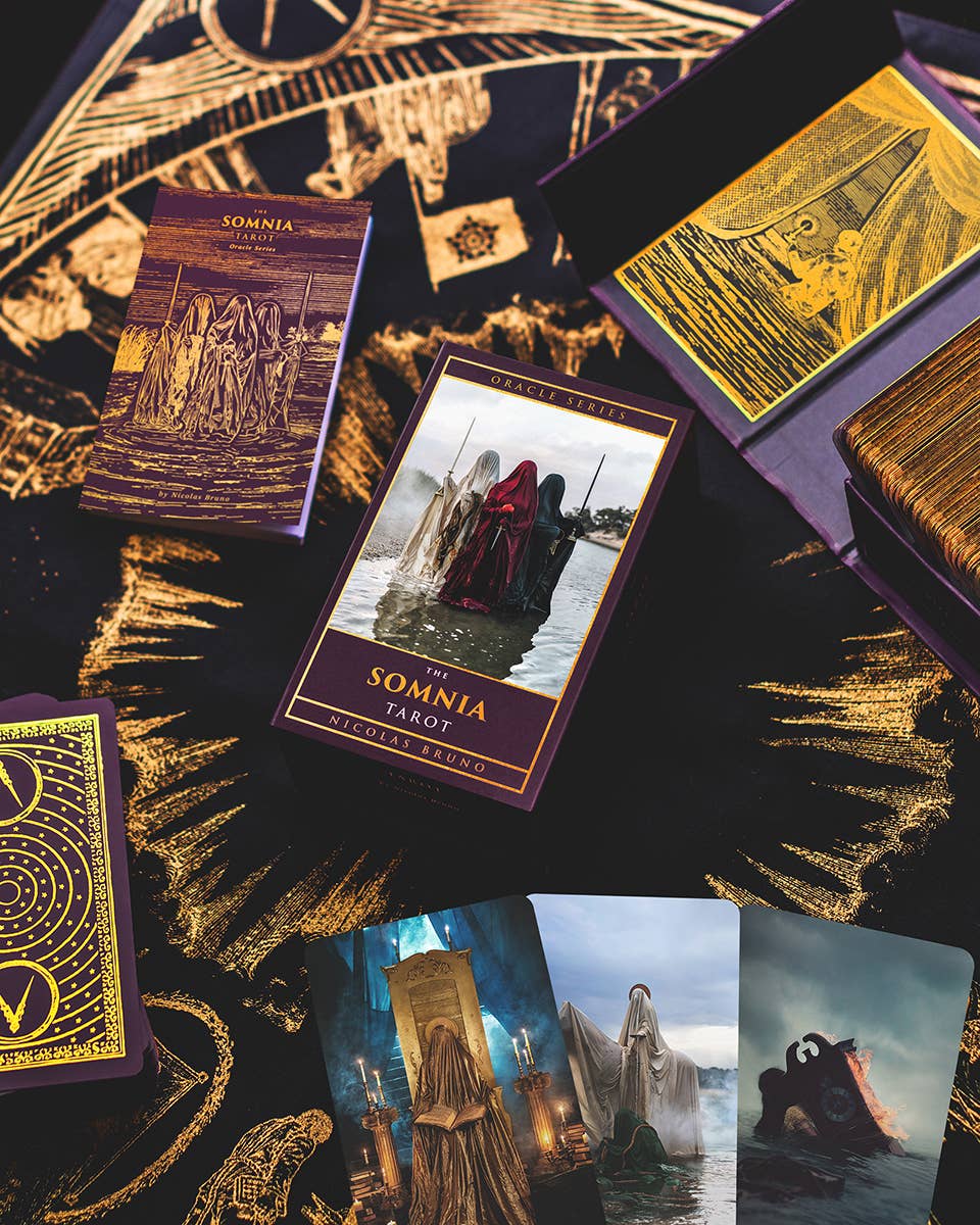 Tarot cards from 'The Somnia Tarot' with intricate designs and gold accents on a dark background.