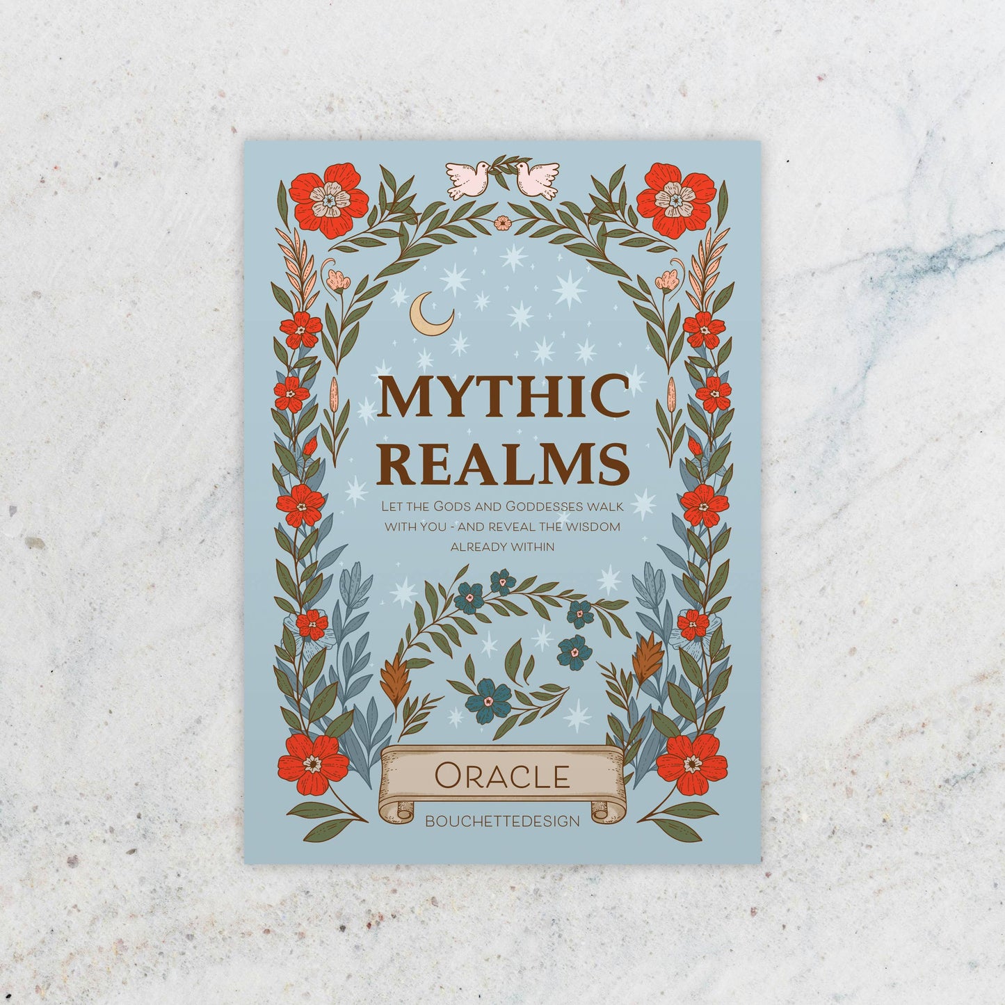 Book cover of 'Mythic Realms Oracle' with floral design on a textured surface