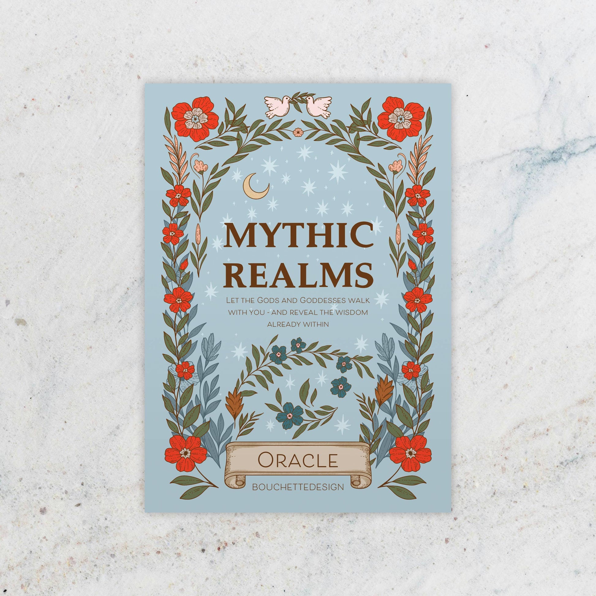 Book cover of 'Mythic Realms Oracle' with floral design on a textured surface