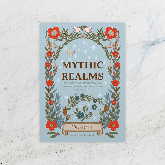 Book cover of 'Mythic Realms Oracle' with floral design on a textured surface