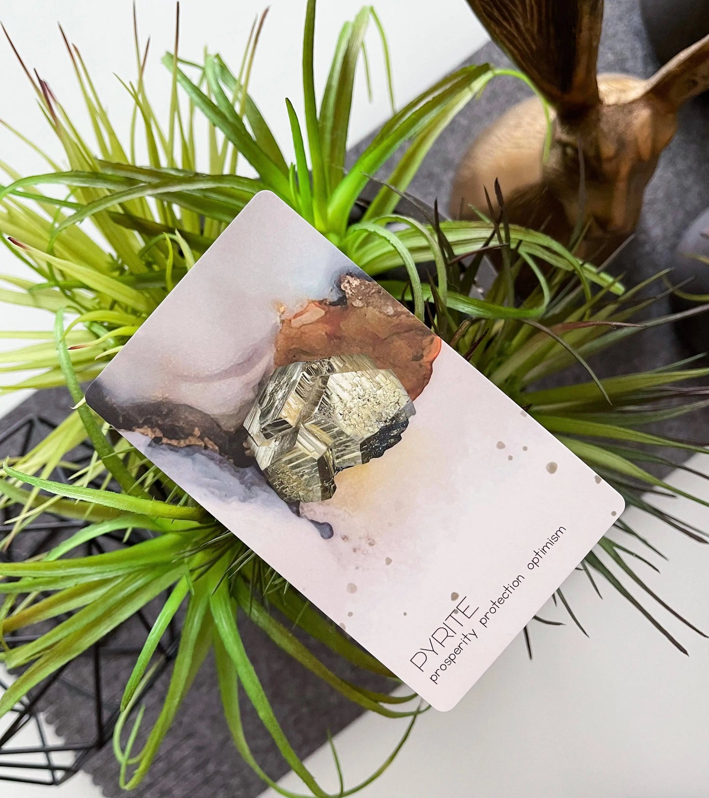 Card with pyrite crystal on a plant background radiant crystal oracle