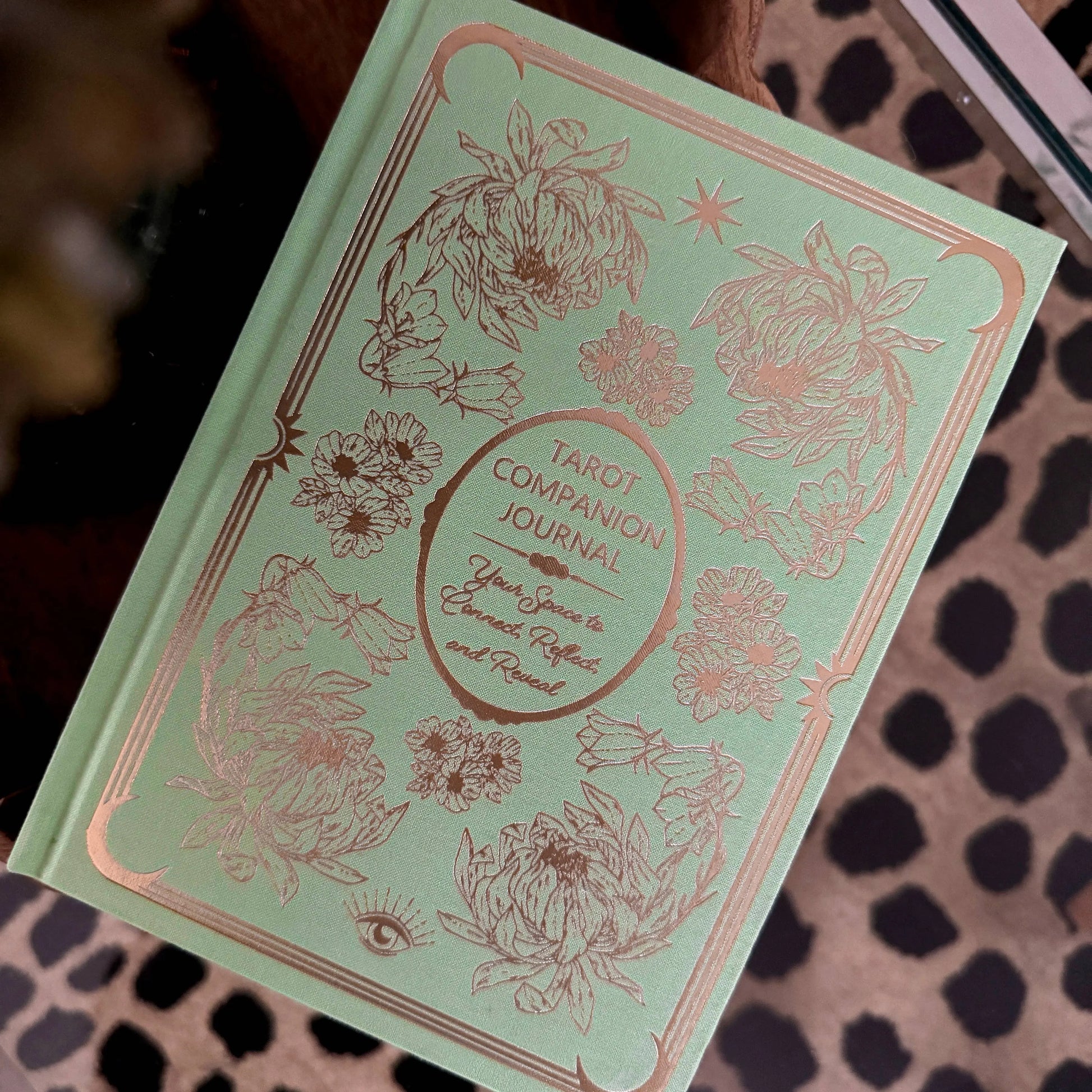 Green tarot companion journal with floral designs on a patterned surface Tarot Journal Bouchette and Co Oneness Emporium