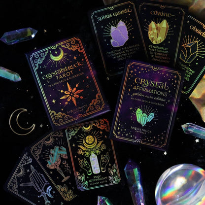 Collection of tarot cards with glowing designs on a dark background with crystals and a crystal ball. Gold Crystal Affirmations Golden Aura Edition featuring luxury affirmation cards inspired by crystal wisdom, mindfulness, and positive daily intentions.