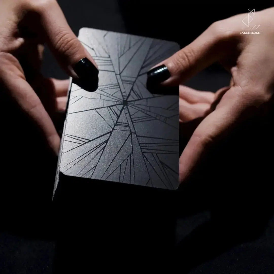 Hands holding a card with a spider web design against a dark background Dark reflections tarot by La Muci Available at Oneness Emporium