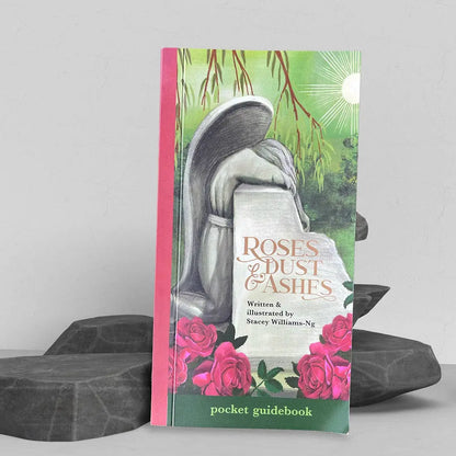 Book titled 'Roses & Dust & Ashes' with a decorative cover featuring a mushroom and flowers.