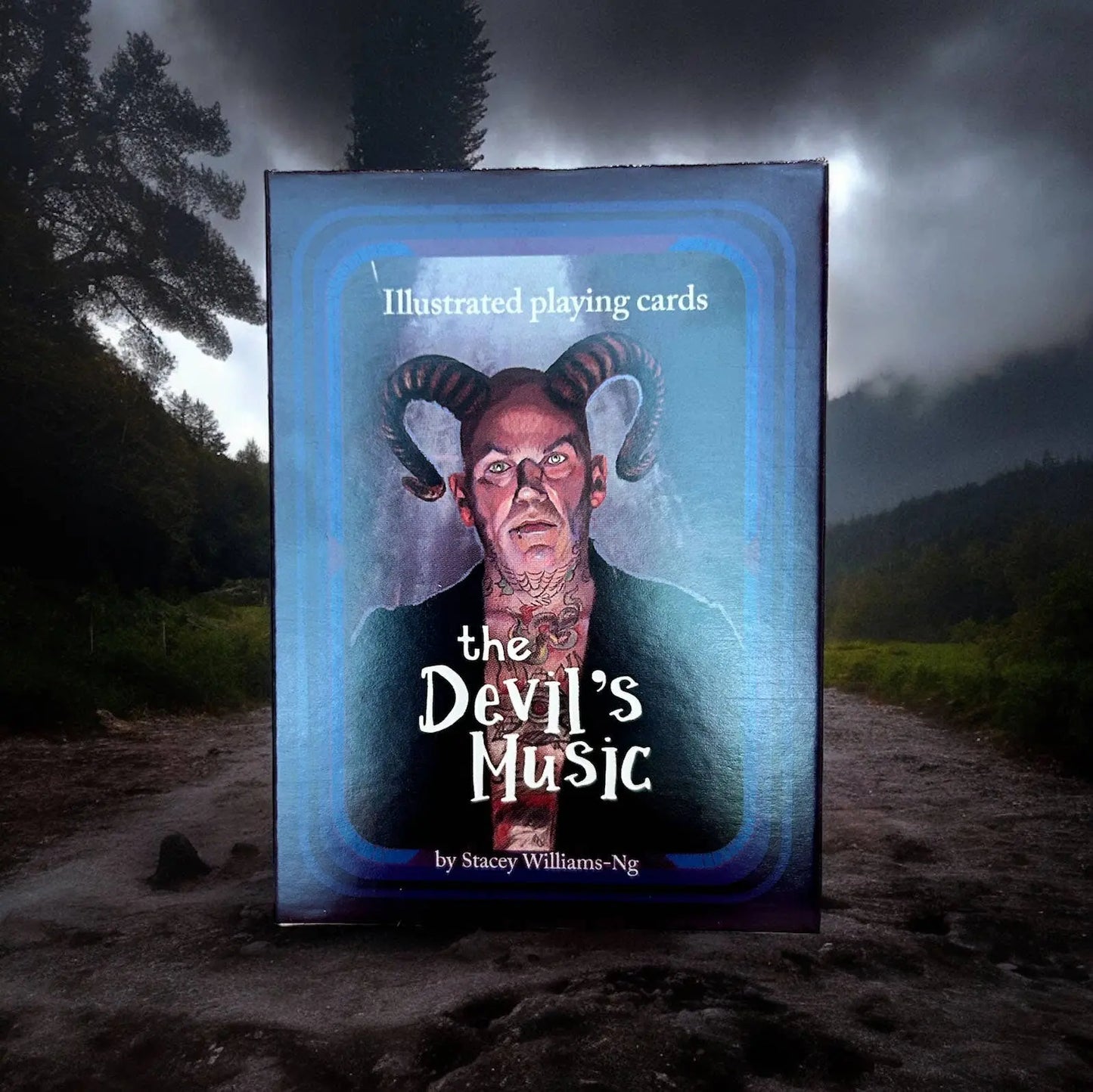 Card box for 'The Devil's Music' illustrated playing cards with a dark, forested background.