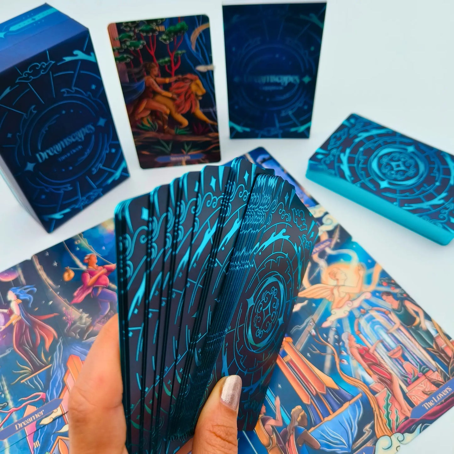 Collection of tarot cards with colorful artwork and a blue box on a white background