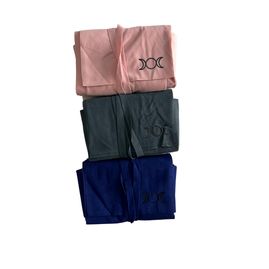 Stack of tarot pouch bags wraps in pink, green, and blue with a symbol on a white background - Oneness Emporium