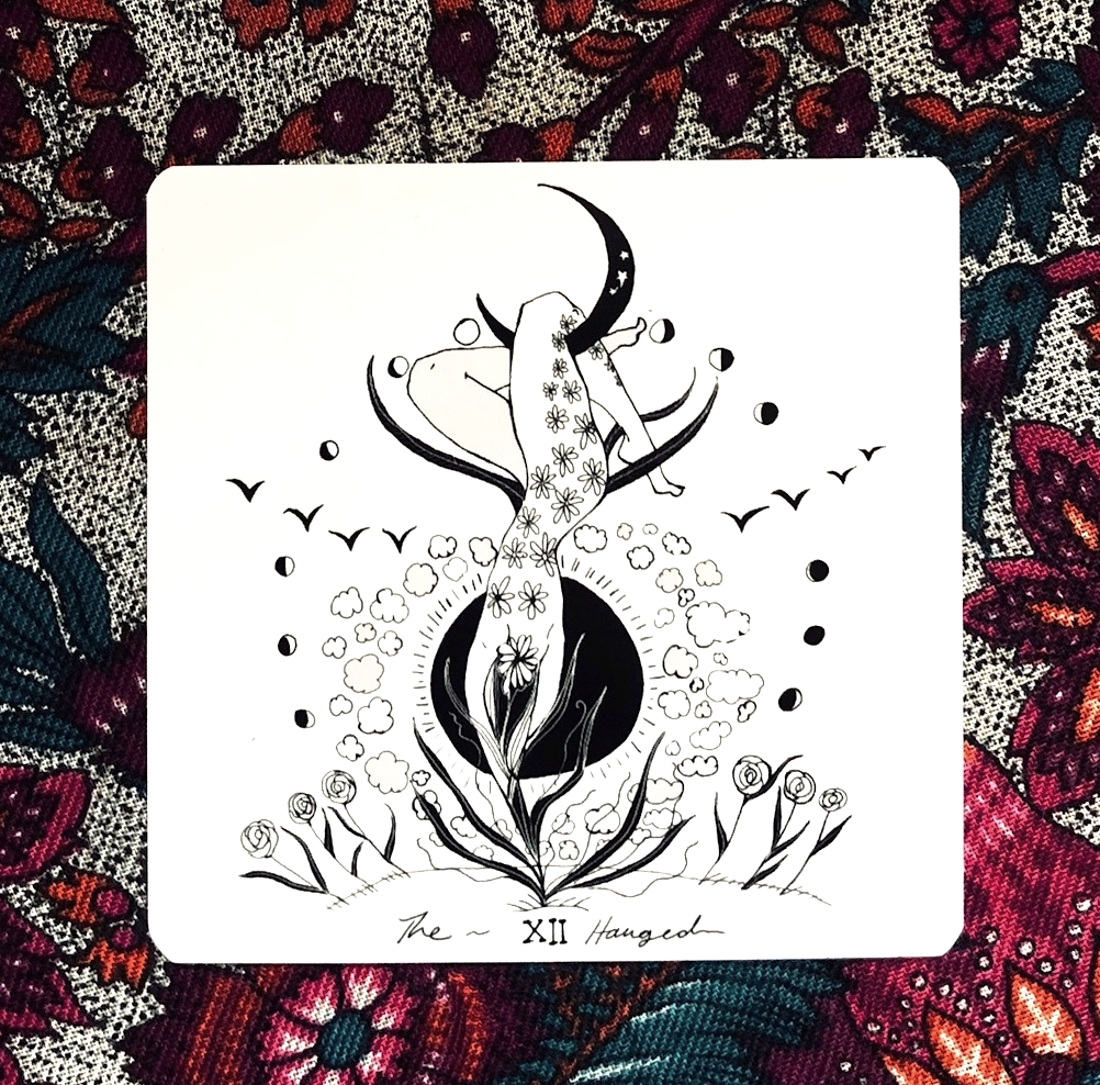 Tarot card with a black and white illustration of a woman and moon on a colorful floral background Dark Days Tarot by Wren McMurdo Brignac featuring square black-and-white tarot cards inspired by the lunar cycle with a 180-page guidebook and collector's box.