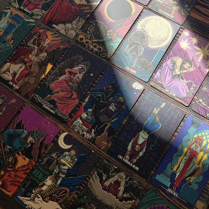 Collection of tarot cards with colorful illustrations on a wooden surface Dark reflections tarot by La Muci Available at Oneness Emporium