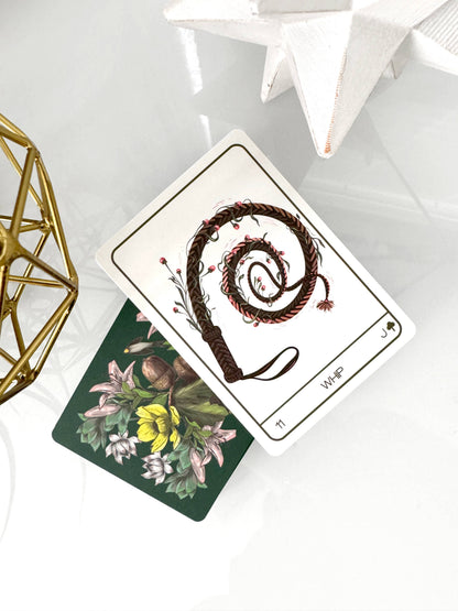 Two tarot cards on a white surface with decorative elements.