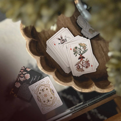 Set of playing cards with nature designs on a glass coffee table 