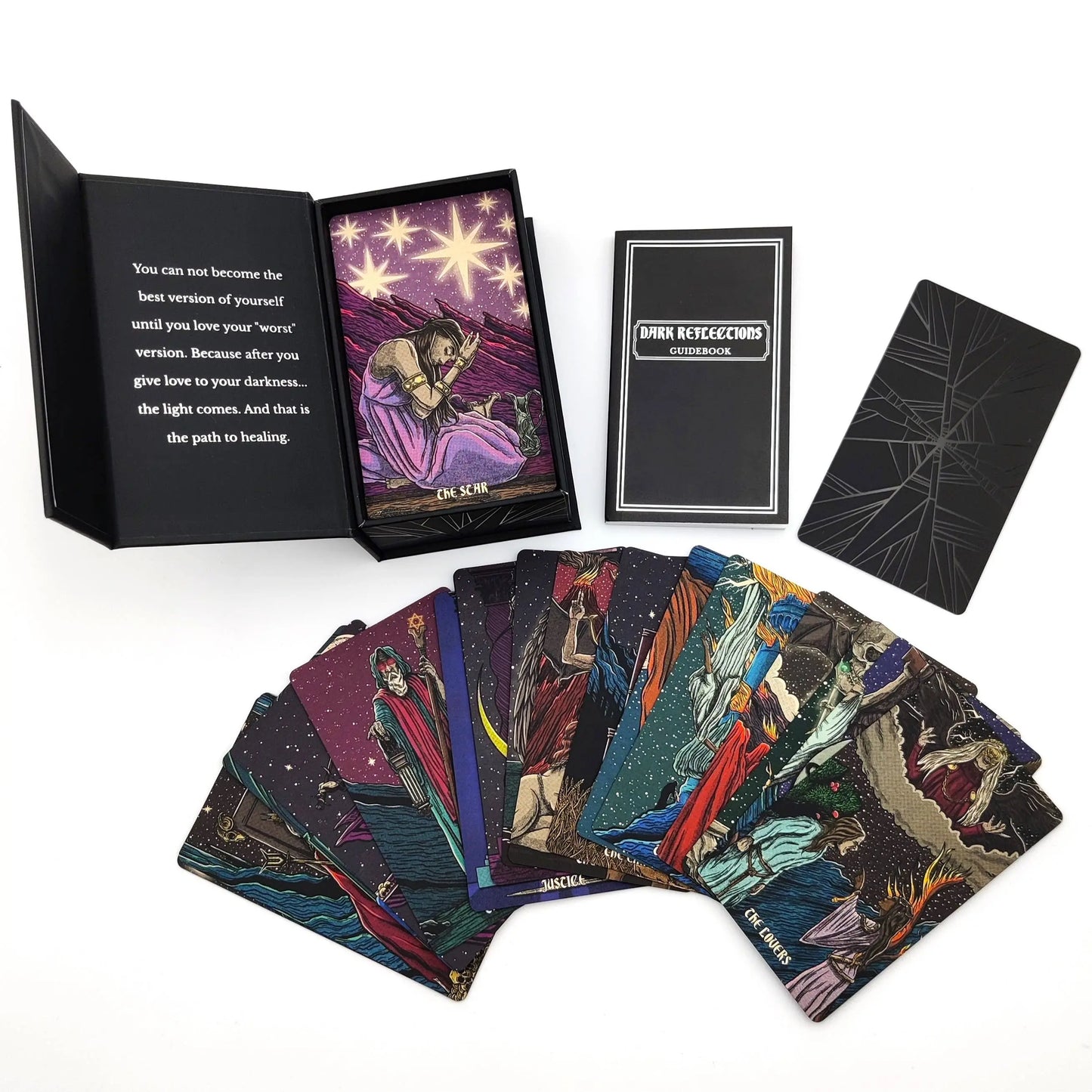 Collection of tarot cards with a deck, book, and card displayed on a white background - Dark reflections tarot by La Muci Available at Oneness Emporium