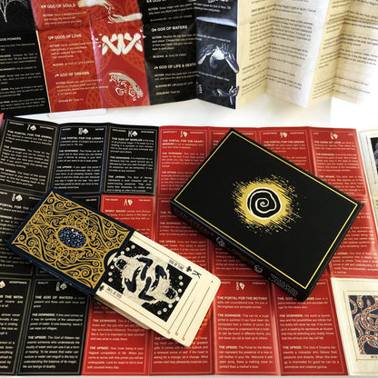 Collection of playing cards with intricate designs on a red and black patterned surface.