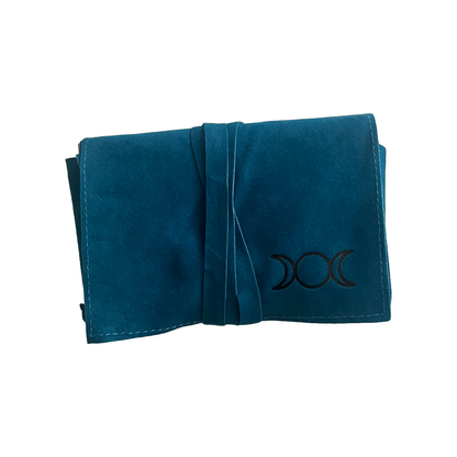 Folded teal tarot pouch with a black triple moon symbol on a white background