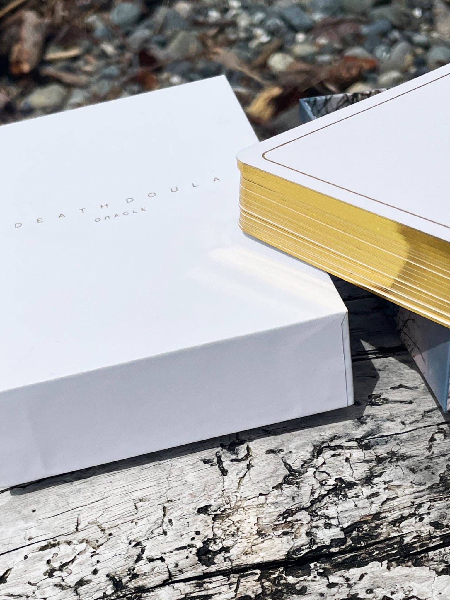 Death Doula Oracle Cards featuring original analogue 35mm photography with double exposure imagery, gold gilded edges and a guidebook for spiritual transformation and healing.
