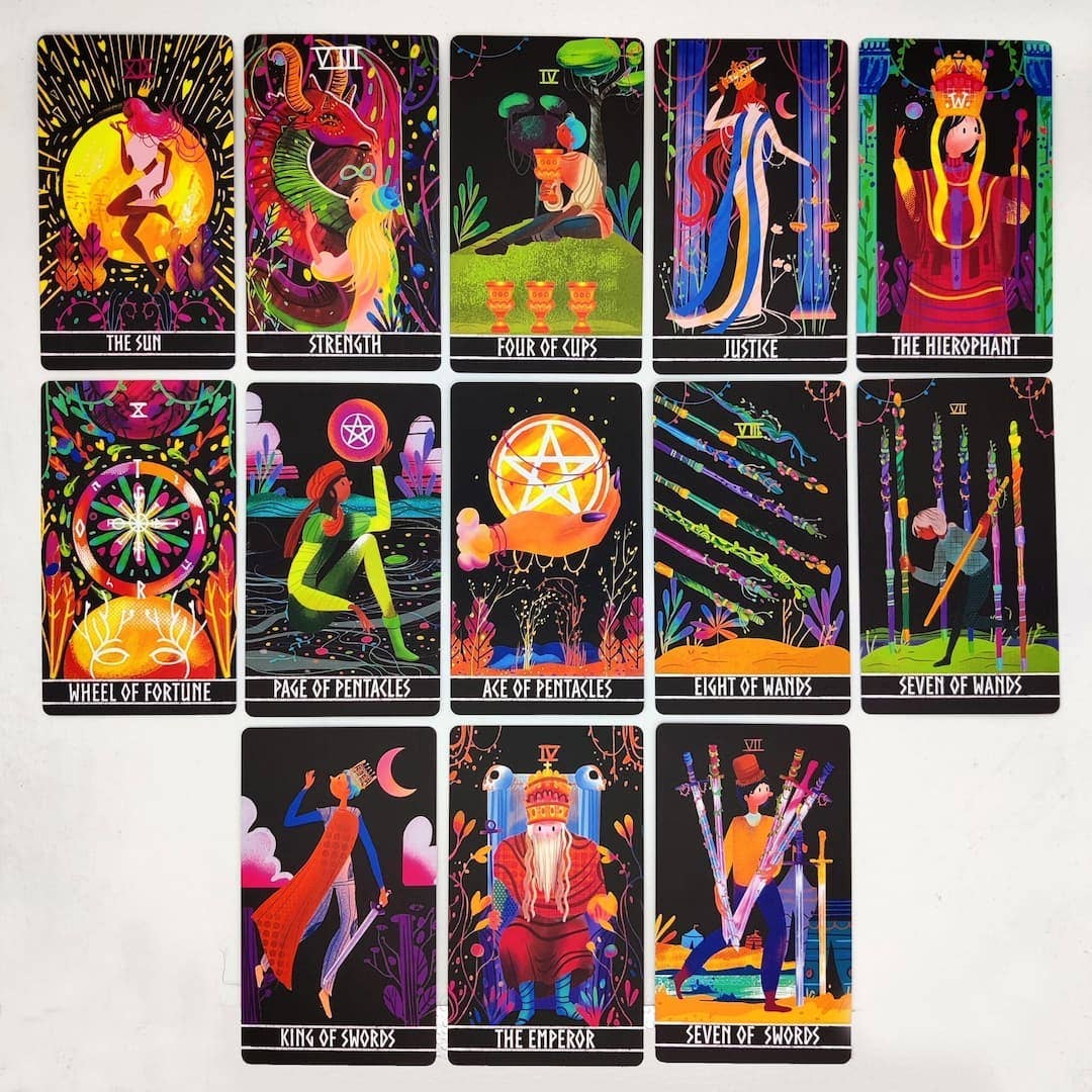 Set of colorful tarot cards with various symbols and designs on a white background