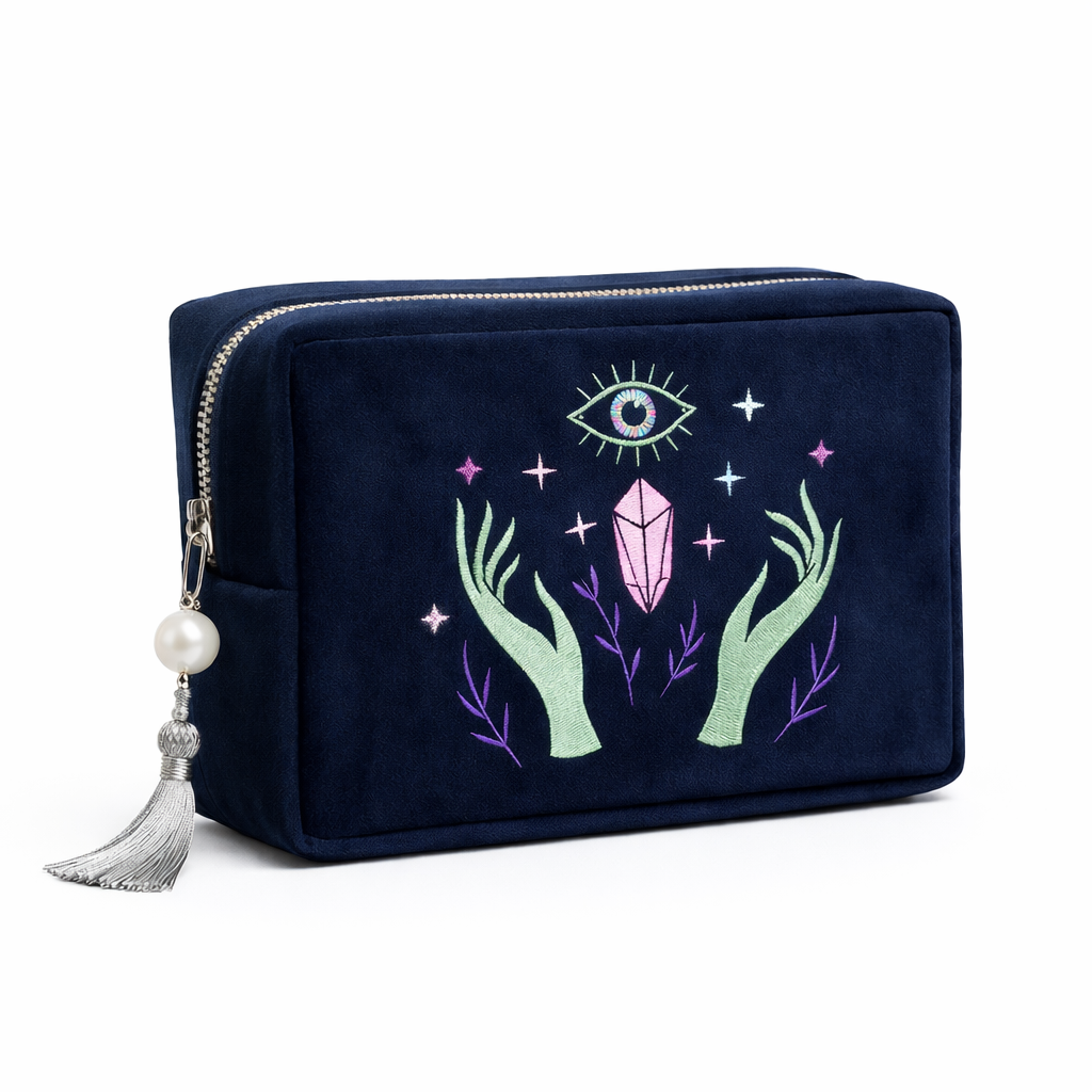 Navy blue pouch with embroidered design of hands holding a crystal and an eye symbol on a white background.