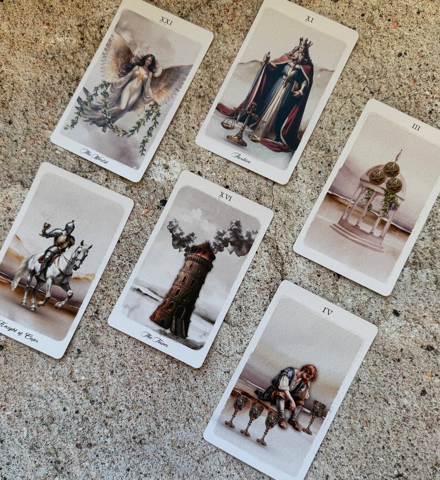 Five illustrated tarot-style cards arranged on a textured stone surface. The cards show vintage fantasy and historical scenes with figures, a horse, a tower, and a seated figure, and the card numbers are visible at the top.