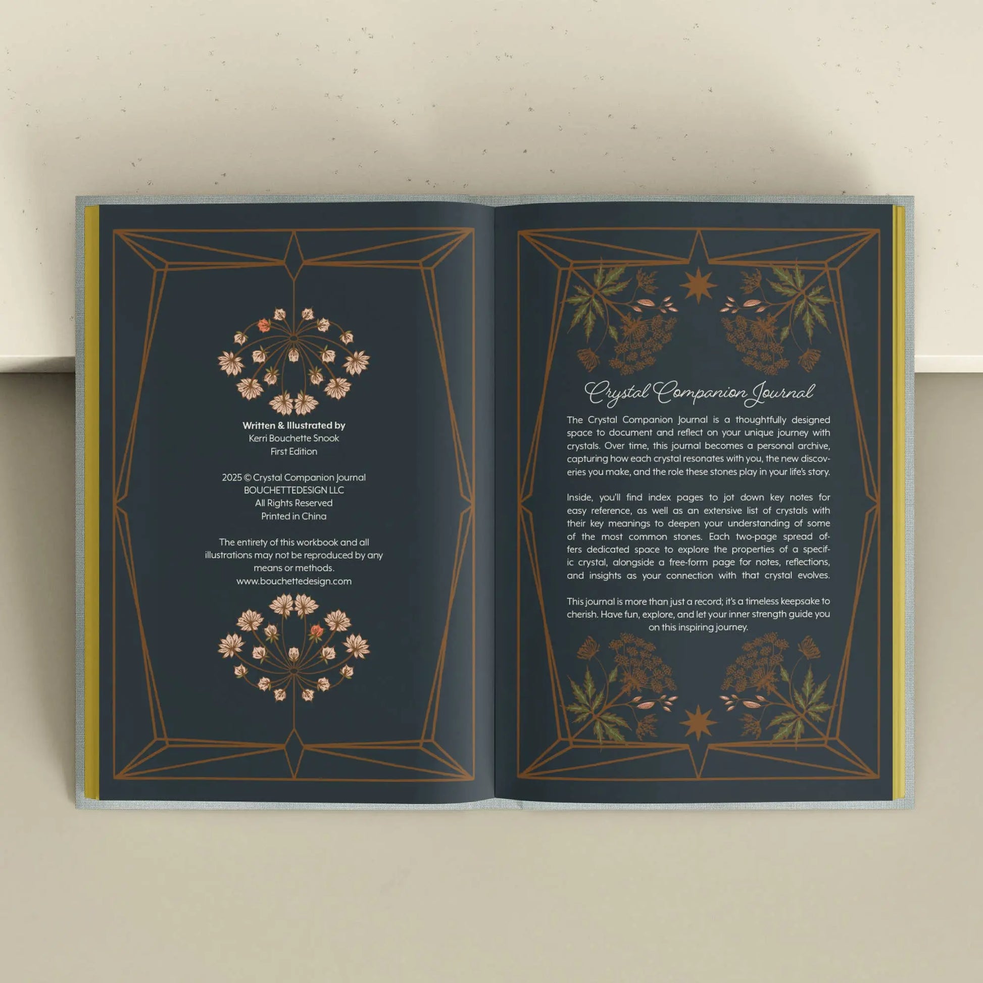 Open book with decorative pages on a light background Crystal companion journal by Bouchette and Co available from Oneness Emporium