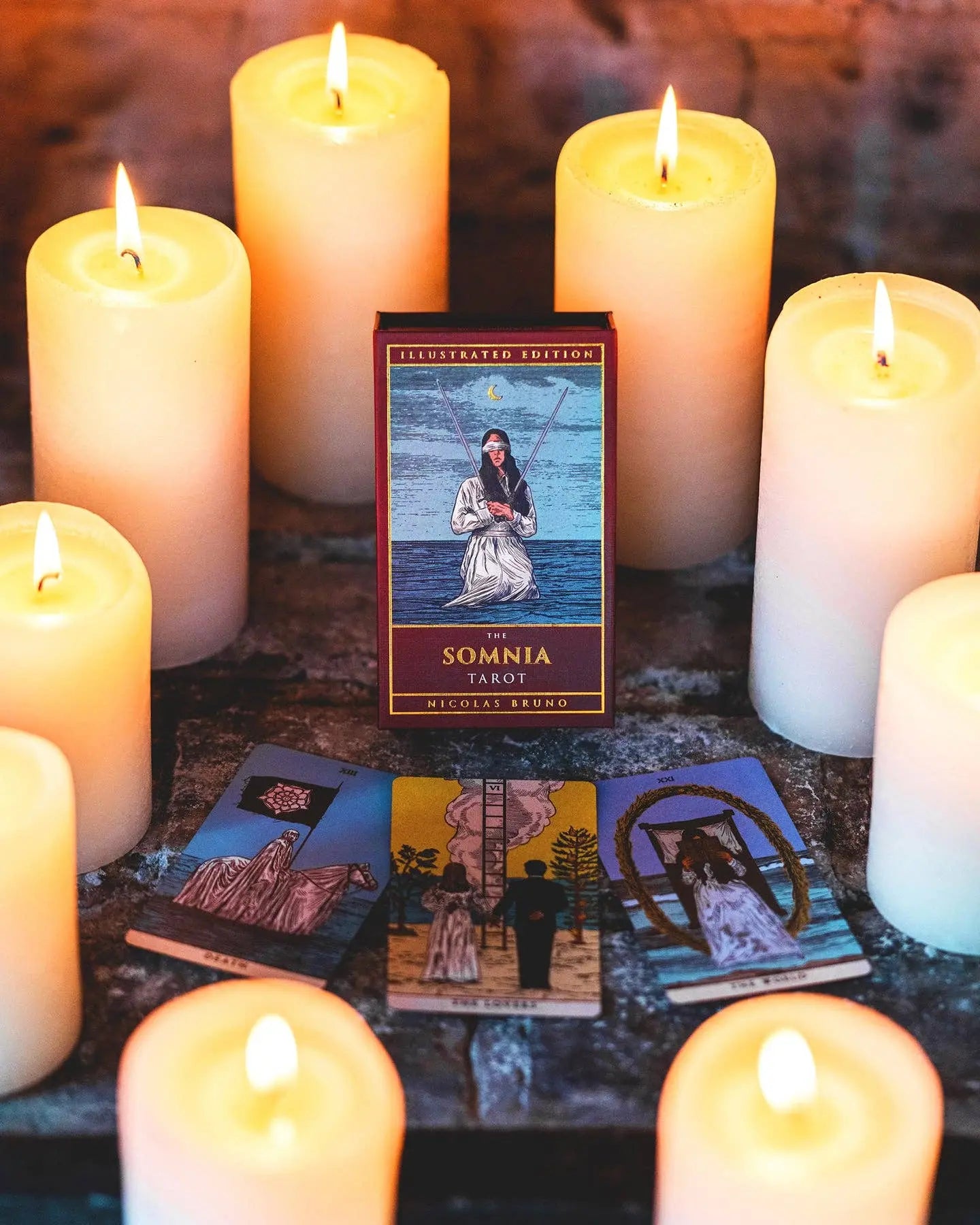Tarot cards and candles on a dark surface with 'The Sonnja Tarot' box.