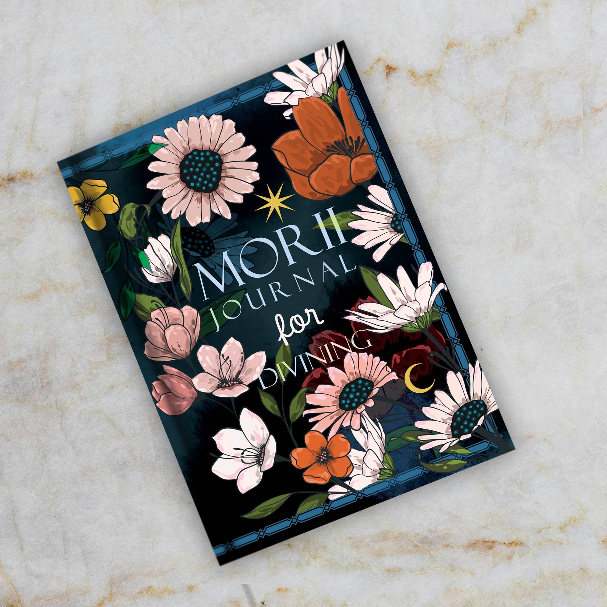 Journal with floral design on a marble surface