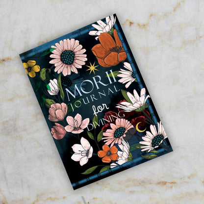 Journal with floral design on a marble surface
