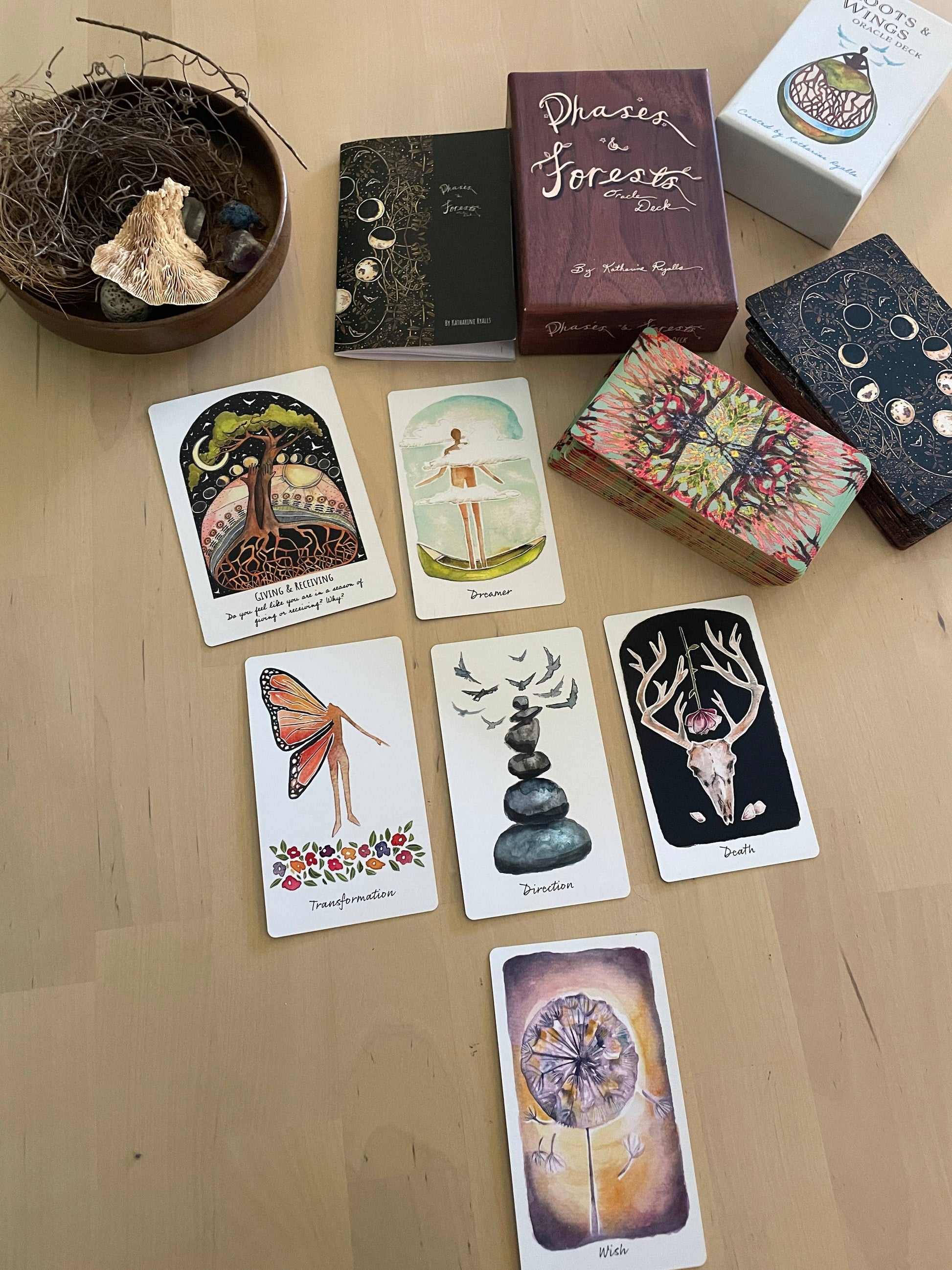 Collection of tarot cards and boxes on a wooden surface