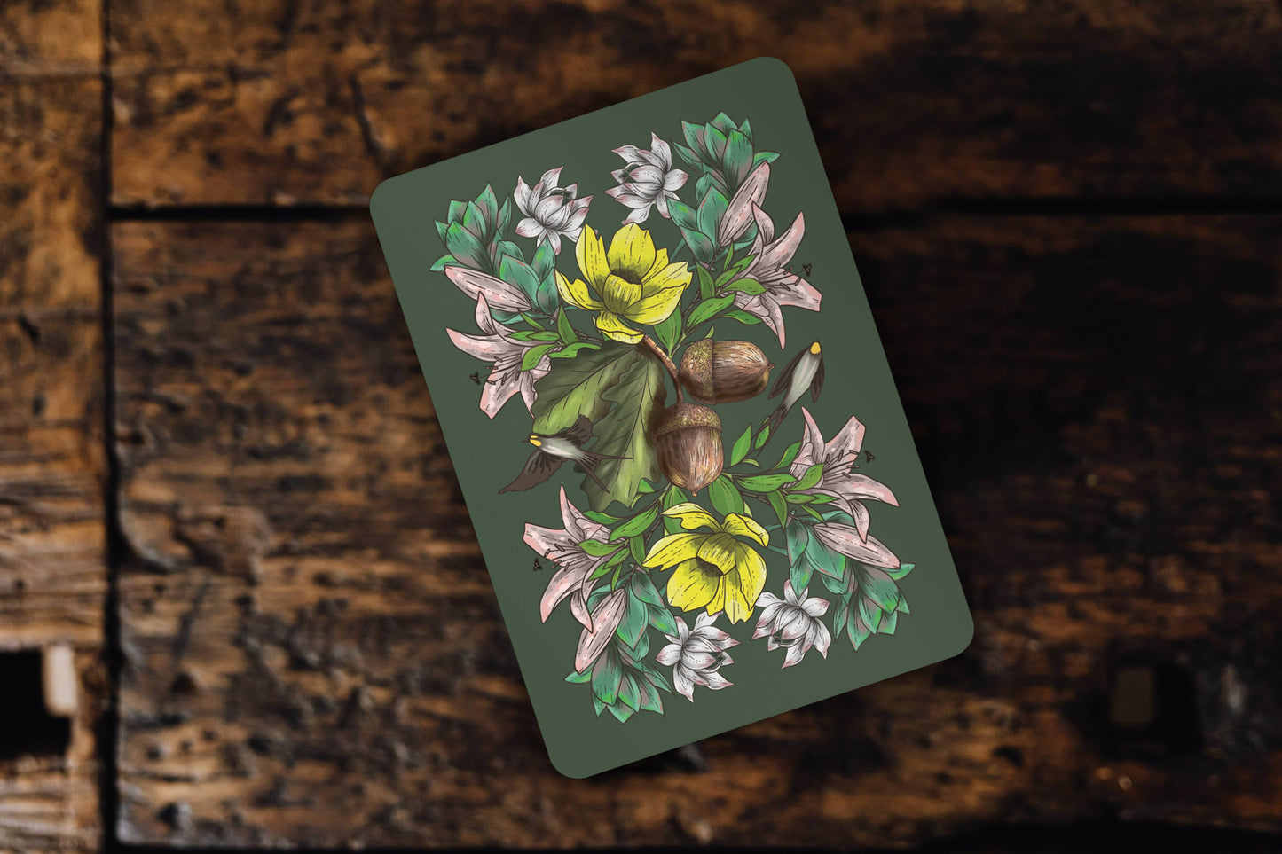 Card with floral design on a wooden surface