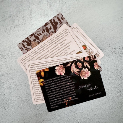 Set of cards with floral designs and text on a textured surface