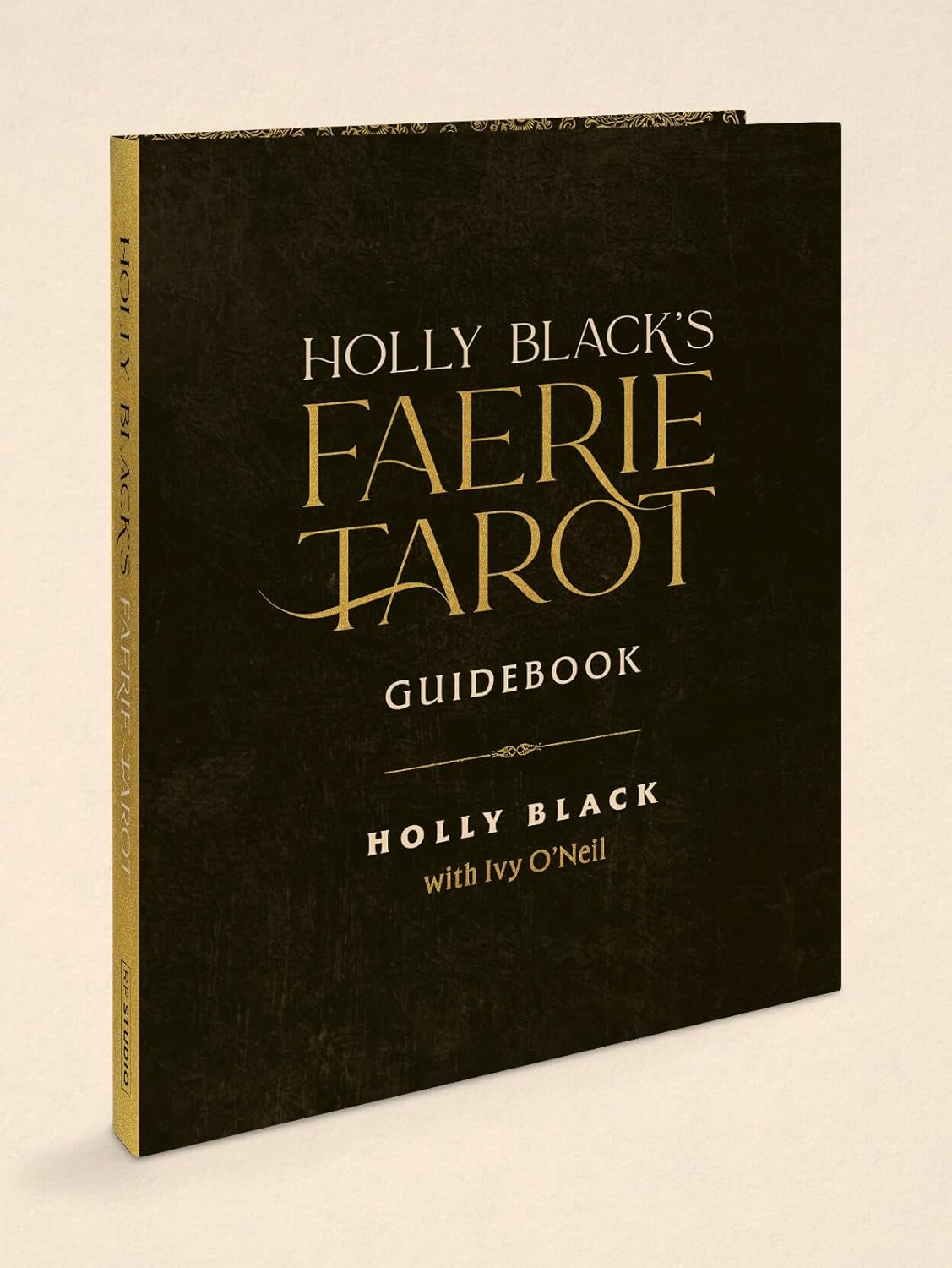 Holly Black's Faerie Tarot Guidebook, featuring a textured black cover with elegant gold and white lettering, shown standing upright on a light beige background.