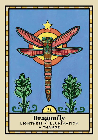 A tarot-style card illustration featuring a dragonfly over a yellow sun on a blue background, with two green plants at the bottom and the text 'Dragonfly' and 'LIGHTNESS + ILLUMINATION + CHANGE' on a cream panel. The card is framed by a decorative border.