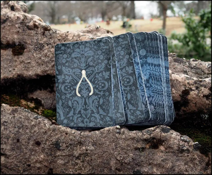 Blue patterned book on a stone surface with a blurred outdoor background