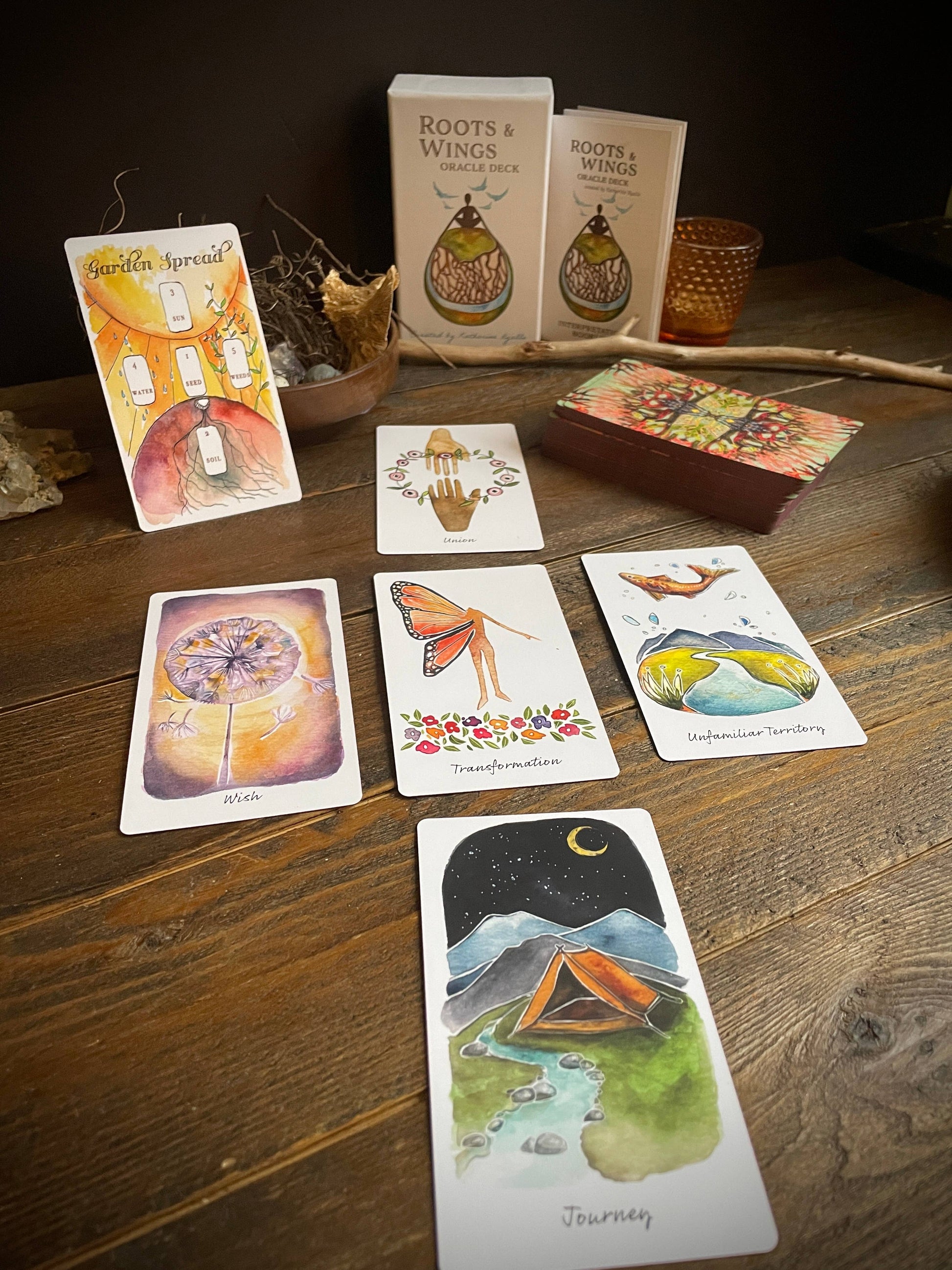 Set of tarot cards and boxes on a wooden surface with a dark background