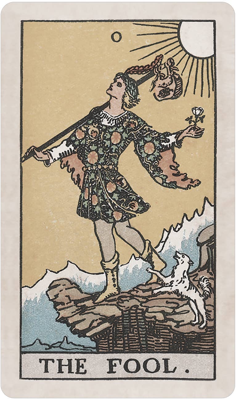 Tarot card featuring 'The Fool' with a person standing on a rock, holding a sword and a flower, with mountains and sun in the background. Pamela Colman Smith's RWS Tarot Deck Soft Color Edition by U.S. Games Systems featuring muted vintage colours, ivory borders, and the original Rider-Waite-Smith artwork.