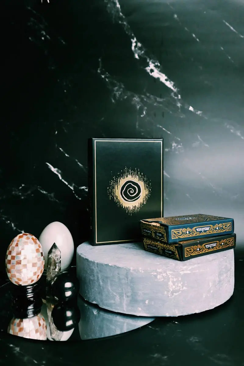 Decorative items on a marble surface with a dark marble background