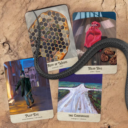 Collection of tarot cards on a textured surface with a rope