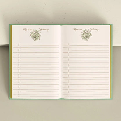 Open notebook with lined pages and decorative elements on a light Tarot Journal Bouchette and Co Oneness Emporium background